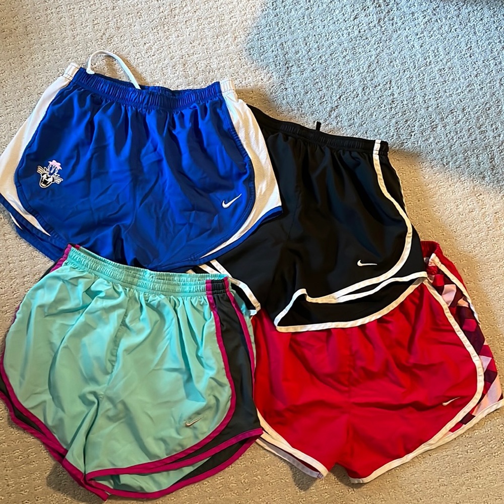 Lot if 4 Nike Women’s size small running shirts.